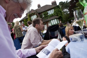 Audience at an outdoor theatre event with the house in the background at Shaw's Corner, Hertfordshire.